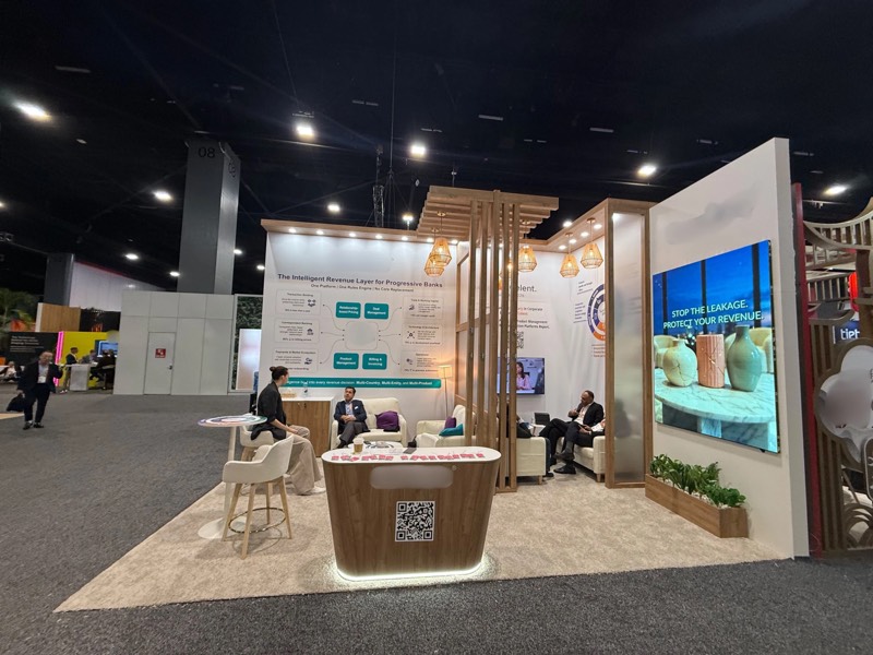 Curved reception counter with QR code, lounge seating and LED screen at the wood and white stand, SIBOS 2026